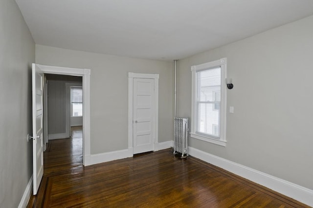 empty room with dark wood-type flooring