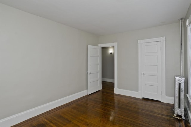 unfurnished bedroom featuring dark hardwood / wood-style flooring