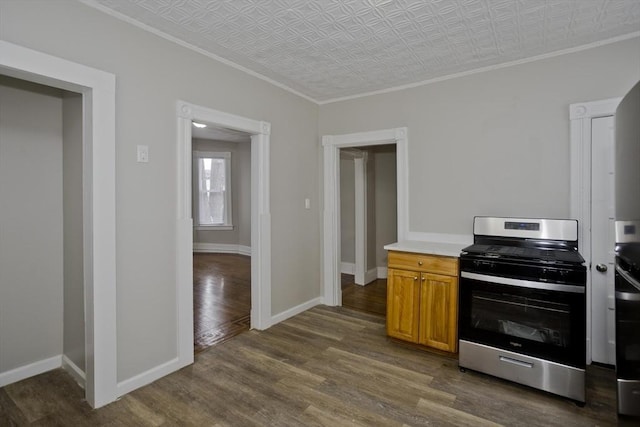 kitchen featuring crown molding, dark hardwood / wood-style floors, and stainless steel range