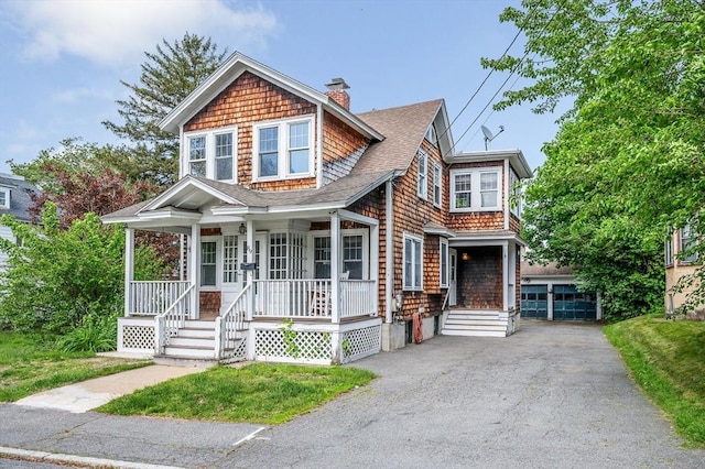89 Merrill Ave, Lowell, MA 01850 - shingle-style home with covered porch, a chimney, and roof with shingles