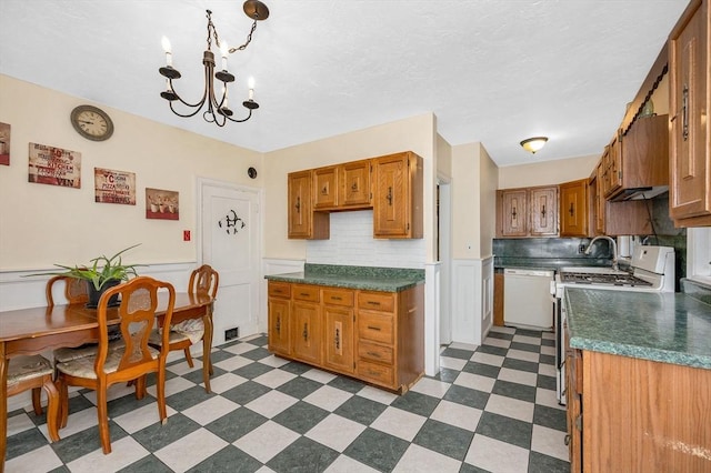 89 Merrill Ave, Lowell, MA 01850 - kitchen featuring white appliances, a chandelier, dark countertops, dark flooring, and wainscoting