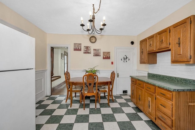 89 Merrill Ave, Lowell, MA 01850 - dining space with a chandelier, dark flooring, and wainscoting