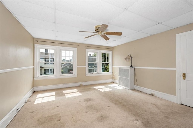 89 Merrill Ave, Lowell, MA 01850 - unfurnished living room featuring a paneled ceiling, carpet flooring, a ceiling fan, and baseboards
