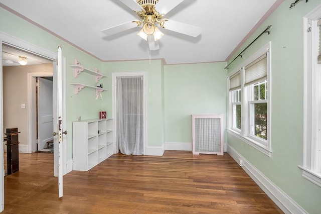 89 Merrill Ave, Lowell, MA 01850 - spare room featuring ceiling fan, wood finished floors, baseboards, and radiator heating unit