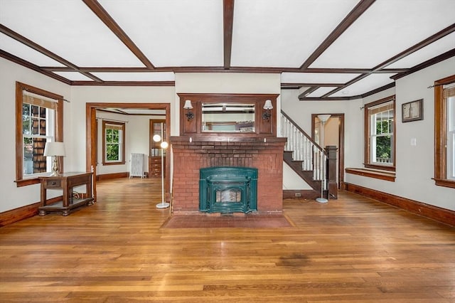 89 Merrill Ave, Lowell, MA 01850 - unfurnished living room with radiator, baseboards, hardwood / wood-style flooring, stairway, and plenty of natural light