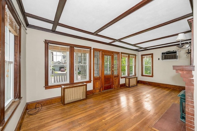 89 Merrill Ave, Lowell, MA 01850 - unfurnished living room with baseboards, hardwood / wood-style floors, radiator heating unit, beam ceiling, and a wall mounted AC