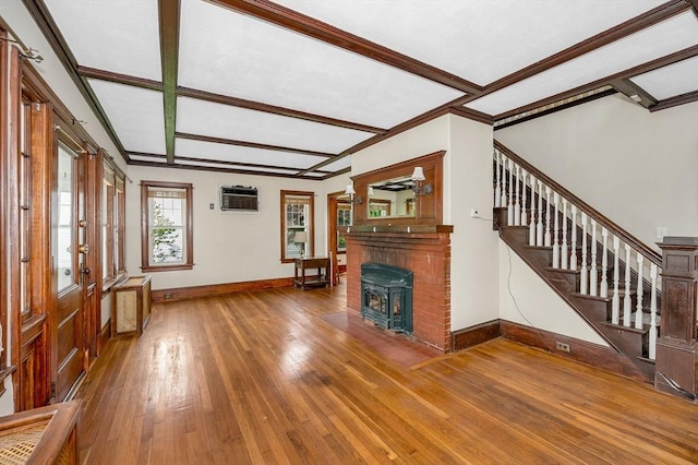 89 Merrill Ave, Lowell, MA 01850 - unfurnished living room featuring hardwood / wood-style floors, stairs, baseboards, an AC wall unit, and a brick fireplace
