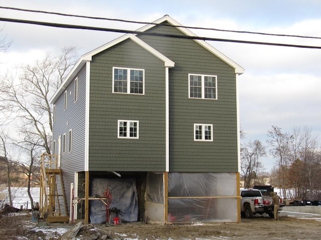 view of snow covered rear of property