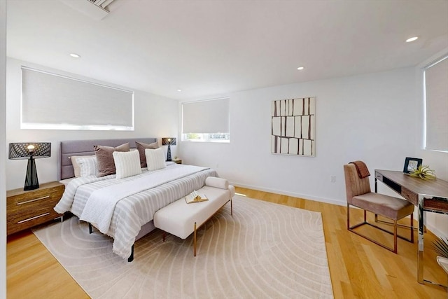 bedroom featuring light wood-type flooring, recessed lighting, and baseboards