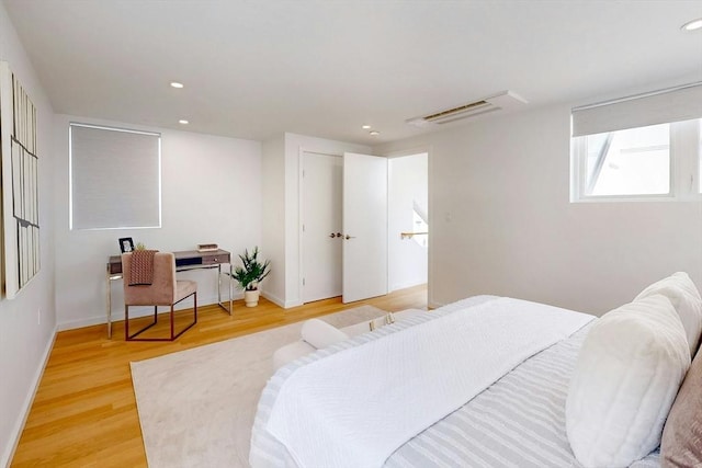 bedroom featuring light wood-style floors, recessed lighting, and baseboards