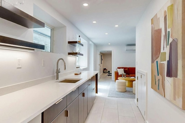 kitchen featuring open shelves, a sink, a wall mounted AC, light countertops, and recessed lighting