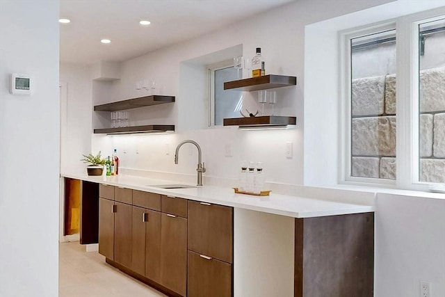 bar area with a sink, recessed lighting, light tile patterned floors, and decorative backsplash