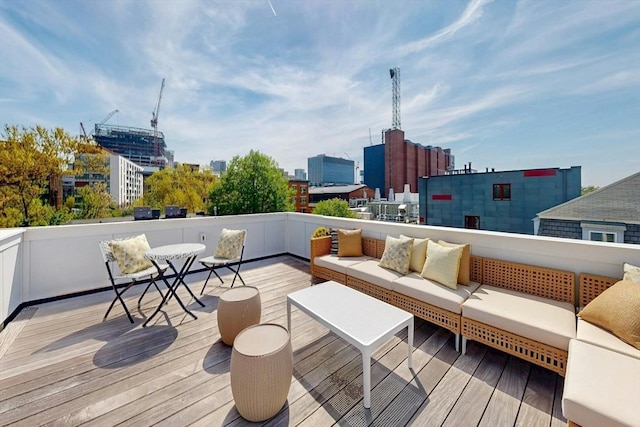 wooden deck featuring an outdoor living space and a view of city