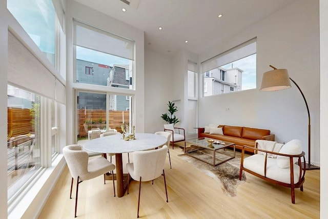 dining room with light wood-style floors and recessed lighting