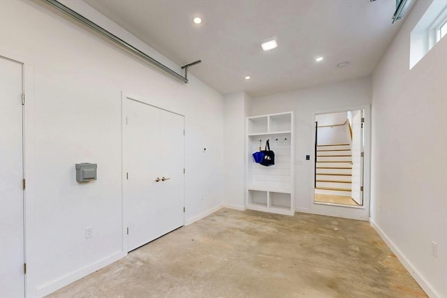 garage with recessed lighting and baseboards
