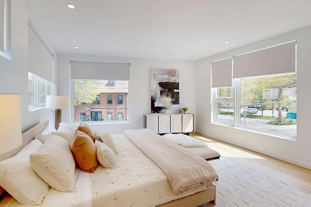 bedroom featuring multiple windows, recessed lighting, and wood finished floors