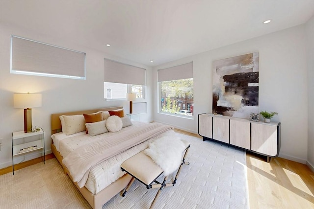 bedroom featuring baseboards, light wood-style floors, and recessed lighting