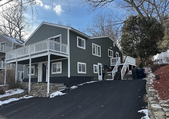 snow covered property with a wooden deck