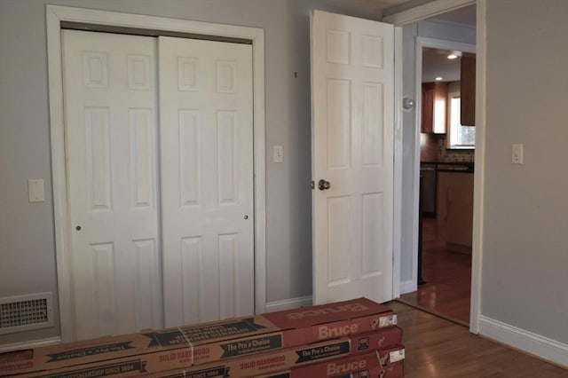 unfurnished bedroom featuring a closet and wood-type flooring