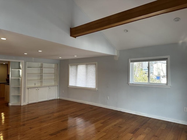 unfurnished living room featuring dark hardwood / wood-style flooring and vaulted ceiling with beams