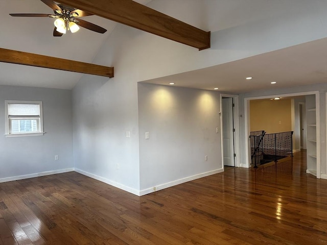 spare room featuring dark wood-type flooring, ceiling fan, and vaulted ceiling with beams