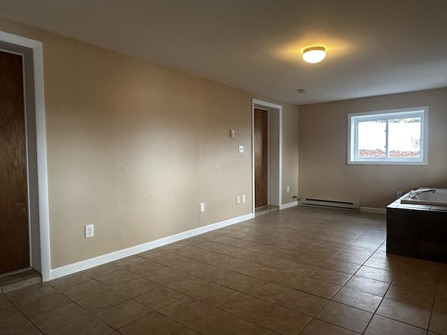 tiled empty room featuring a baseboard radiator