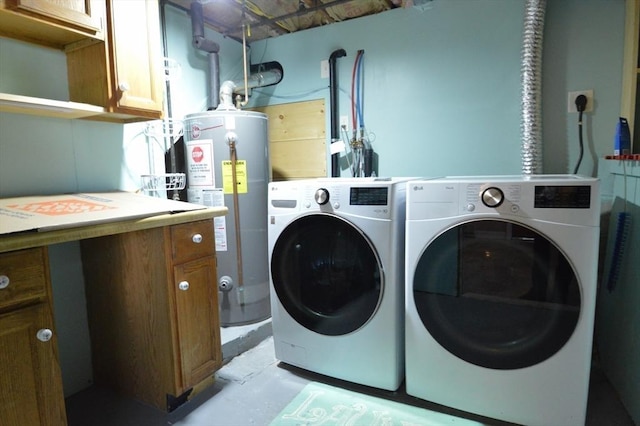 clothes washing area with separate washer and dryer, cabinets, and gas water heater