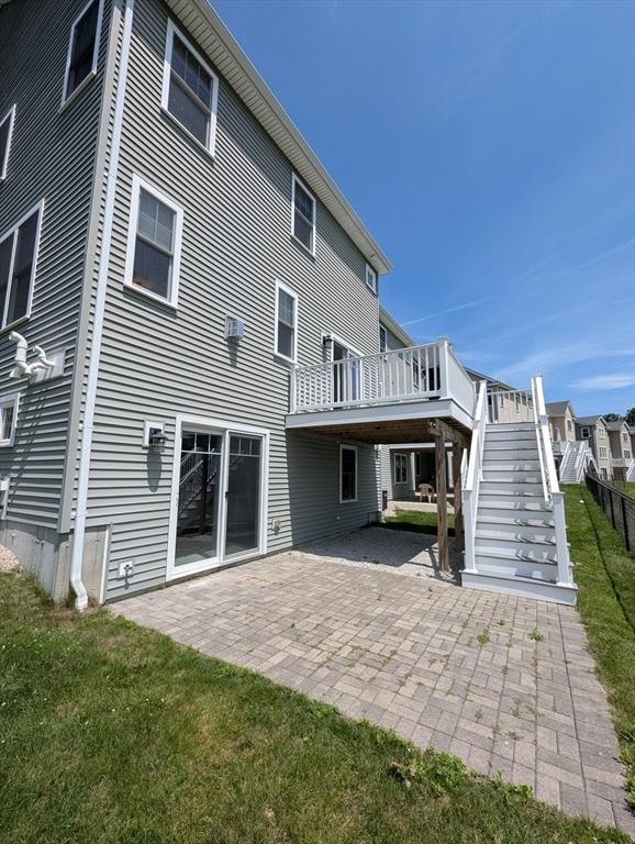50 Brookview Rd Unit 50, Franklin, MA 02038 - back of property featuring a patio, stairway, and a yard