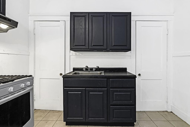 108 Washington St Unit 3, Boston, MA 02135 - kitchen with a sink, stainless steel gas stove, light tile patterned flooring, and dark cabinetry