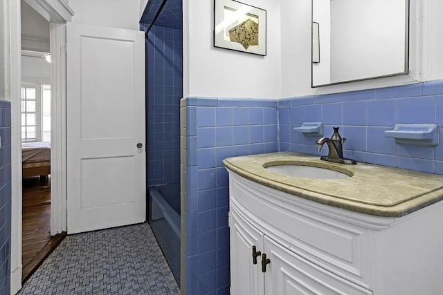 108 Washington St Unit 3, Boston, MA 02135 - full bathroom with vanity, tile walls, shower / washtub combination, and a wainscoted wall