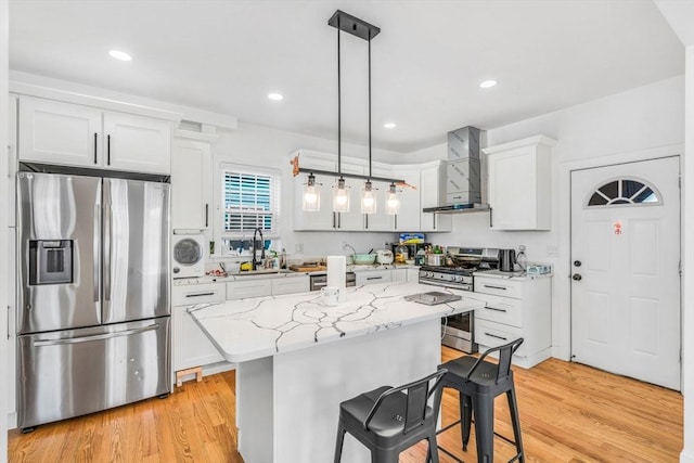 kitchen featuring white cabinetry, decorative light fixtures, and stainless steel appliances