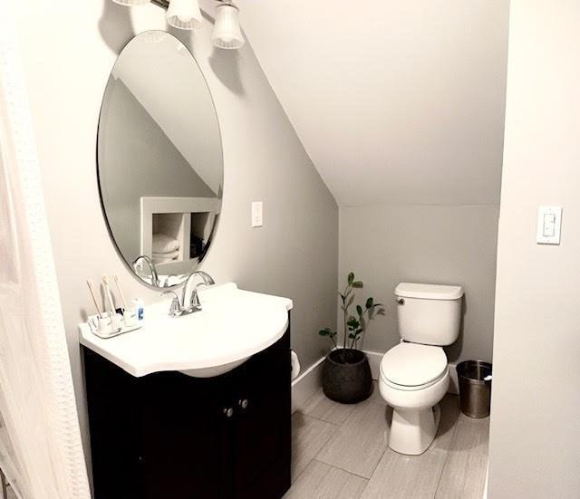 60 King St, Swampscott, MA 01907 - bathroom with vanity, toilet, and vaulted ceiling
