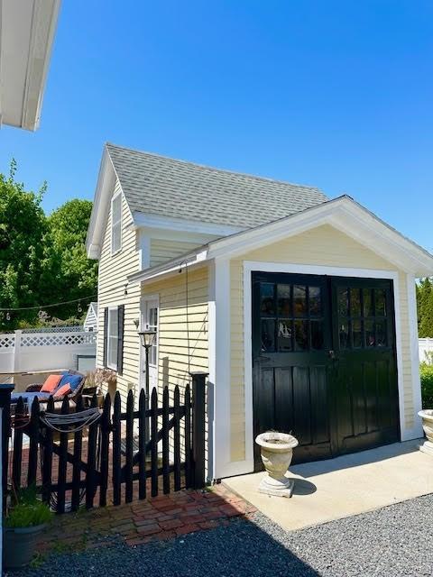 60 King St, Swampscott, MA 01907 - view of home's exterior with roof with shingles and an outdoor structure