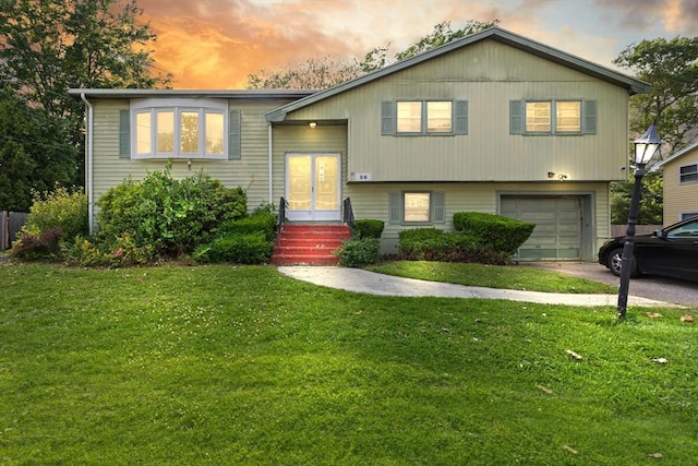 26 Hemlock Ter, Randolph, MA 02368 - split foyer home with an attached garage, a lawn, and driveway