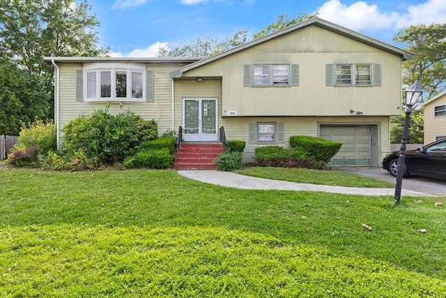 26 Hemlock Ter, Randolph, MA 02368 - bi-level home featuring a garage, driveway, and a front yard