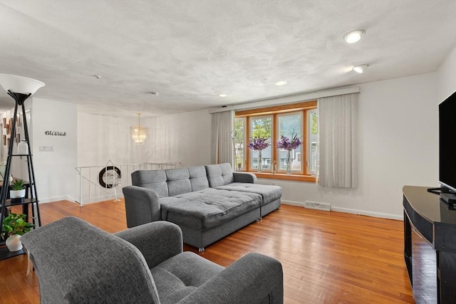 26 Hemlock Ter, Randolph, MA 02368 - living room featuring wood finished floors, baseboards, recessed lighting, and a chandelier