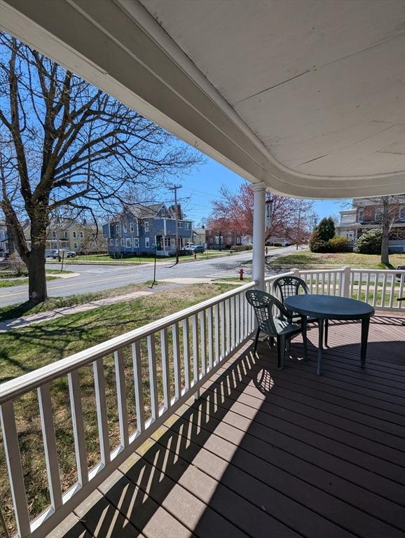 wooden terrace featuring a porch and a residential view