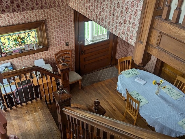 interior space featuring hardwood / wood-style floors and wallpapered walls