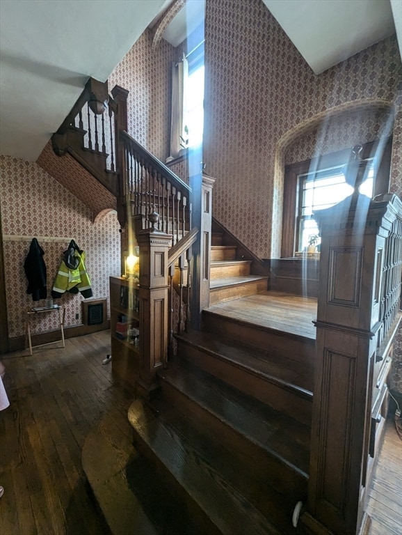 stairway featuring hardwood / wood-style floors and plenty of natural light