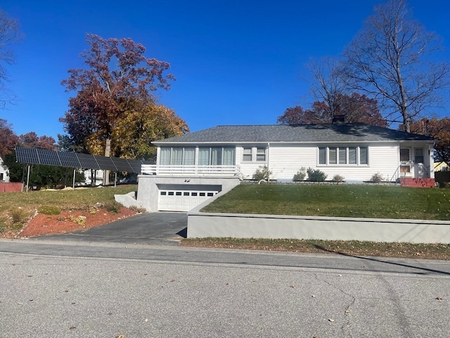 view of front of property with a front yard and a garage