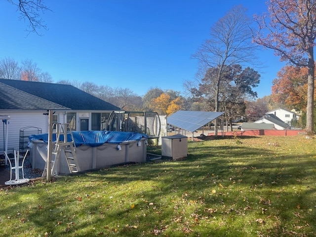 view of yard with a covered pool