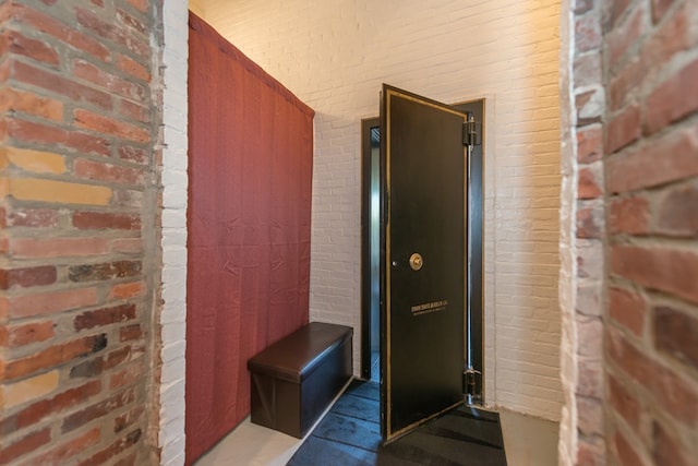interior space featuring brick wall