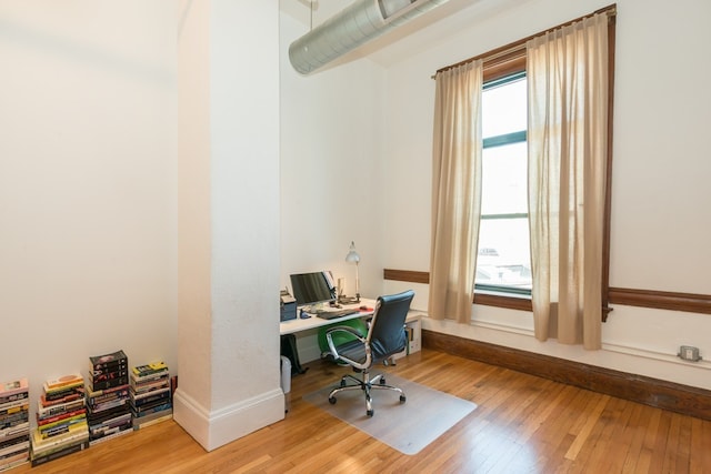 office with baseboards and hardwood / wood-style flooring