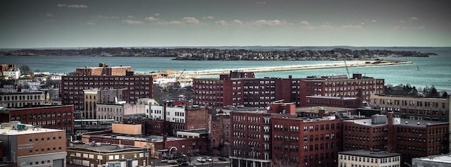 exterior space featuring a view of city and a water view