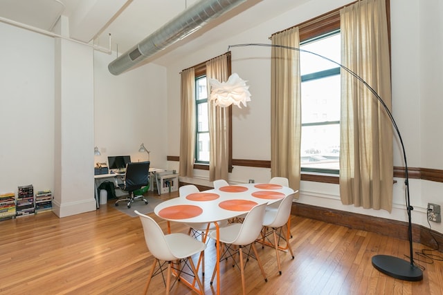dining area featuring baseboards and hardwood / wood-style floors