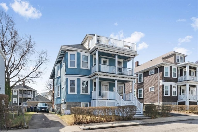 view of front of property featuring a balcony and covered porch