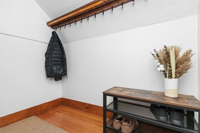 mudroom featuring wood-type flooring and baseboards