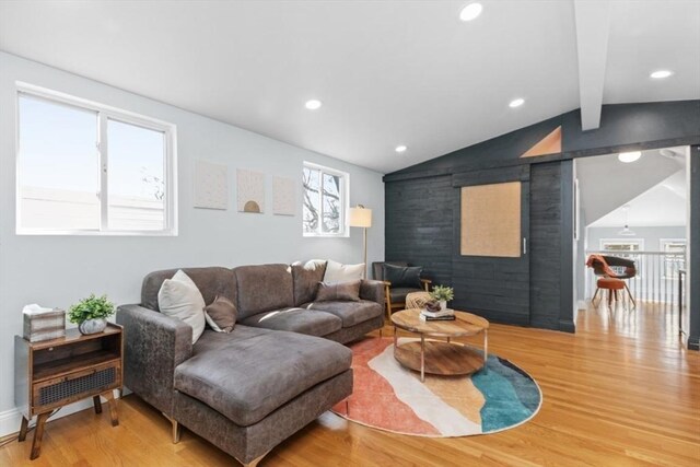 living room with recessed lighting, lofted ceiling with beams, and wood finished floors