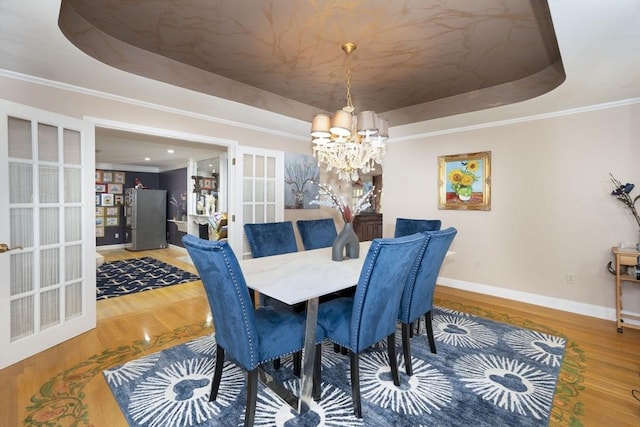 20 Albee Dr, Braintree, MA 02184 - dining area with a raised ceiling, a chandelier, french doors, wood finished floors, and ornamental molding
