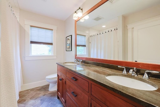 5 Baxter St, Westborough, MA 01581 - bathroom with plenty of natural light, toilet, baseboards, and double vanity
